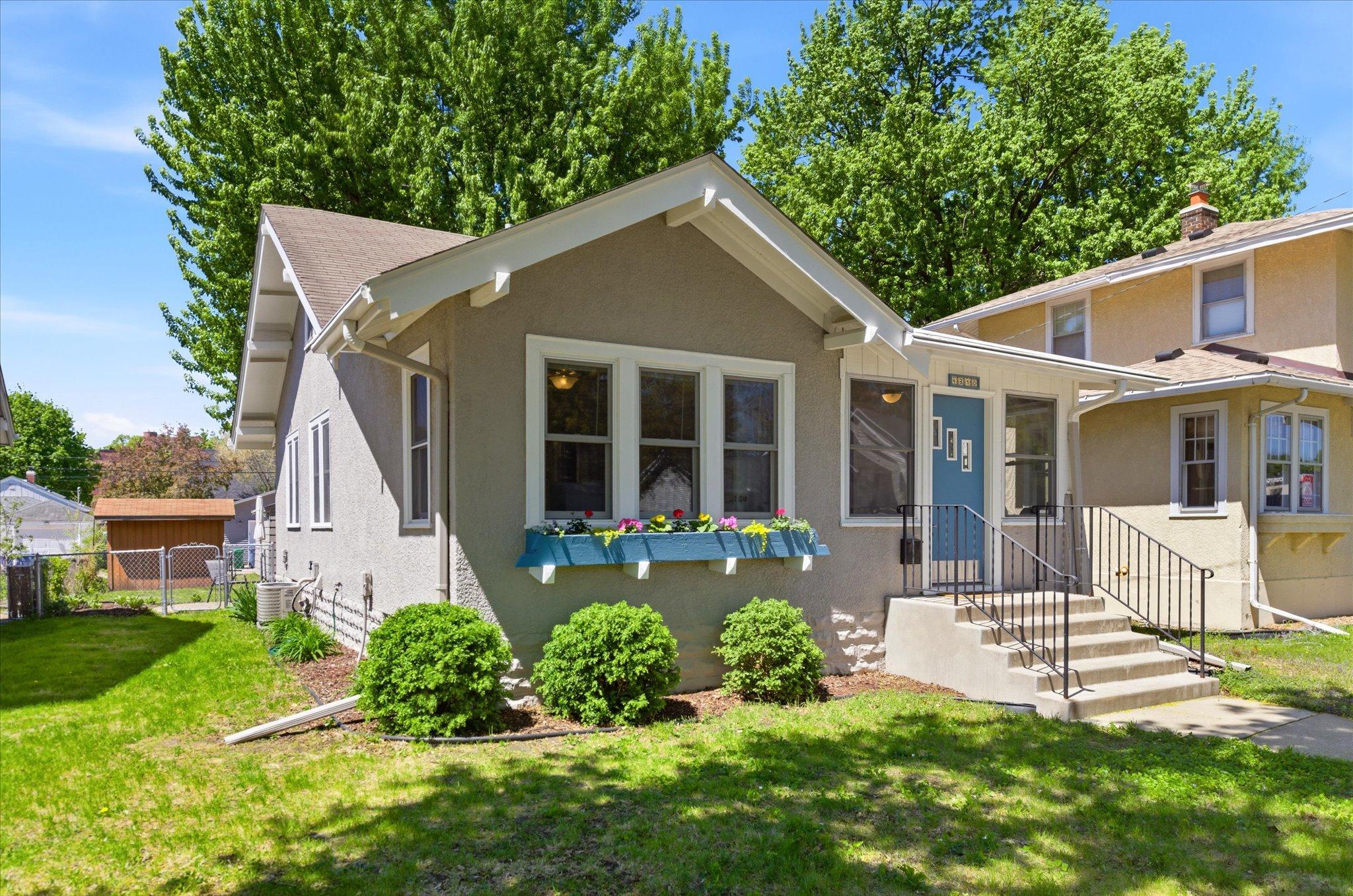 Another view to appreciate—this classic home showcases beautiful architectural character paired with updated windows and fresh exterior touches.
