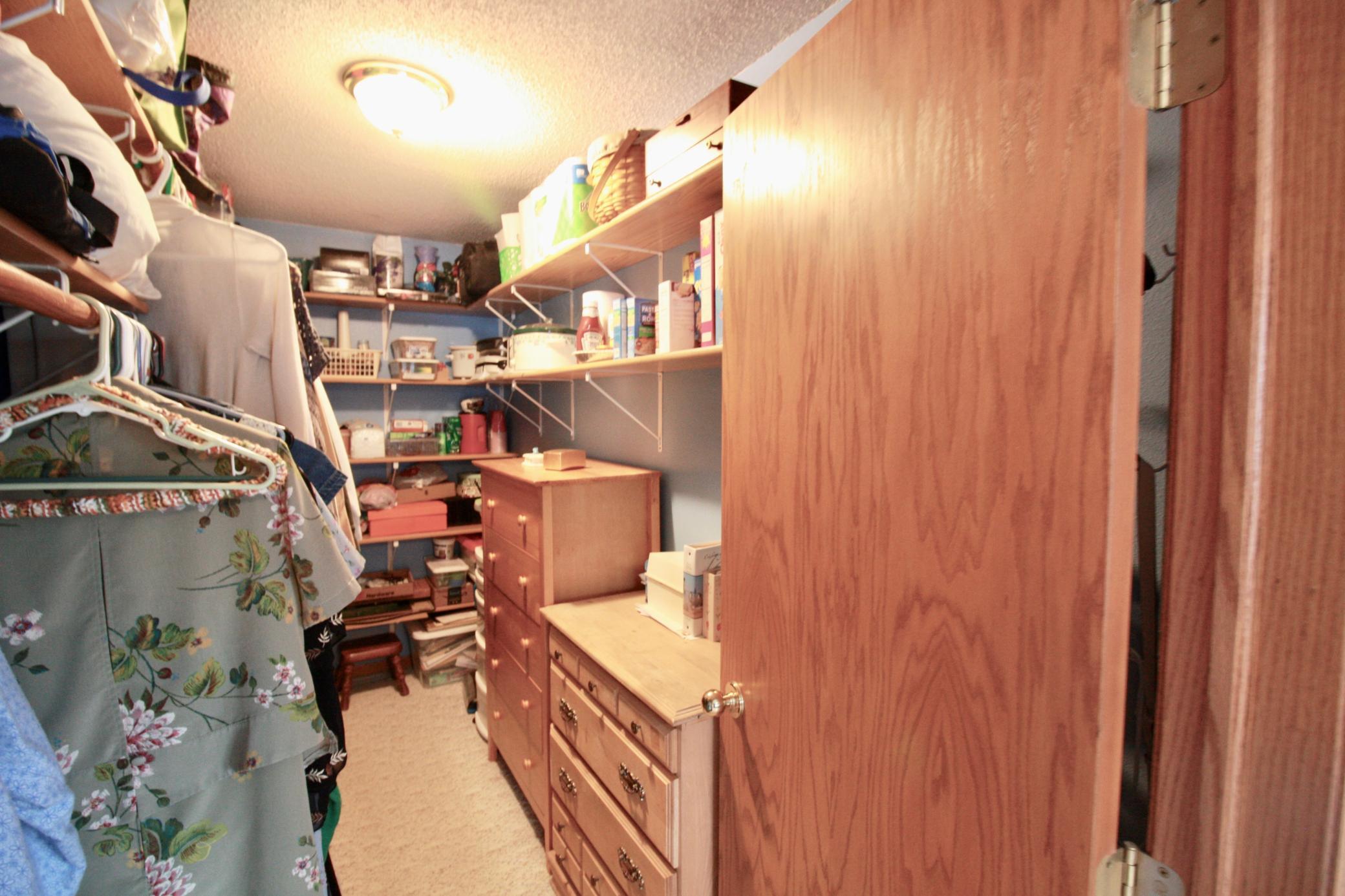Primary bedroom walk in closet