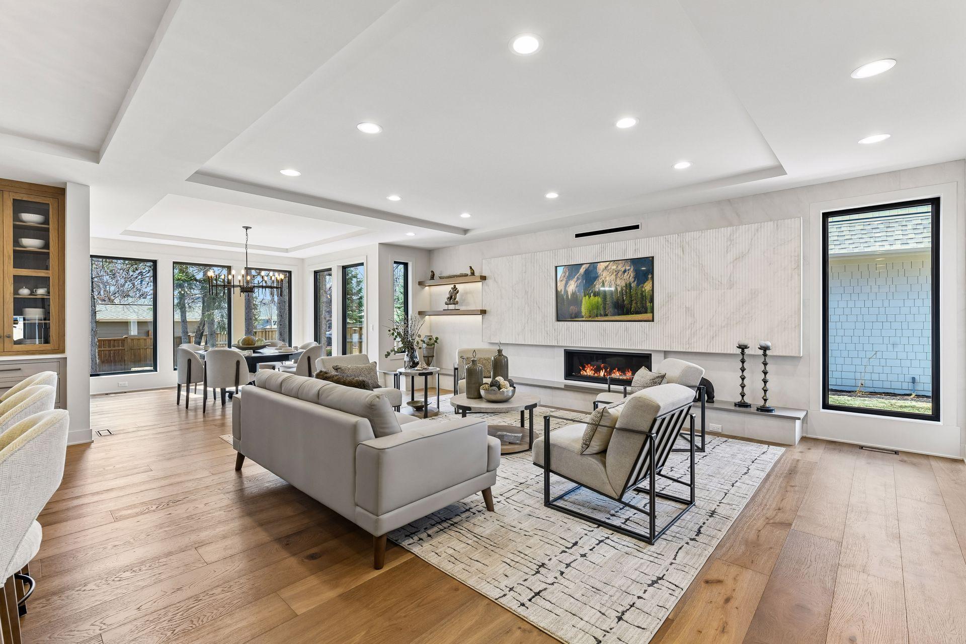 Great room has linear fireplace and adjoins dining area.