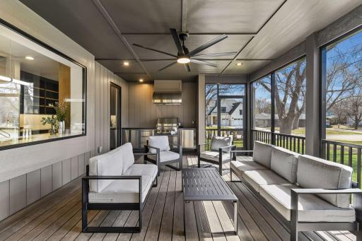 Large screened porch features a Napoleon built-in grill with commercial grade hood.