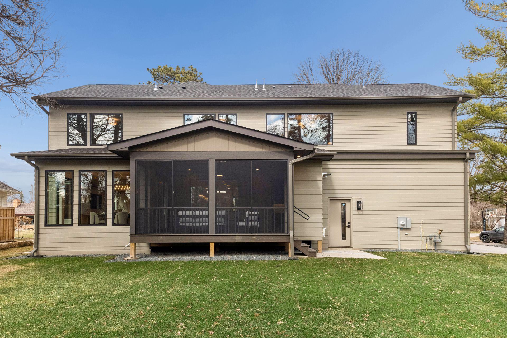 Rear view of home and separate garage access door.