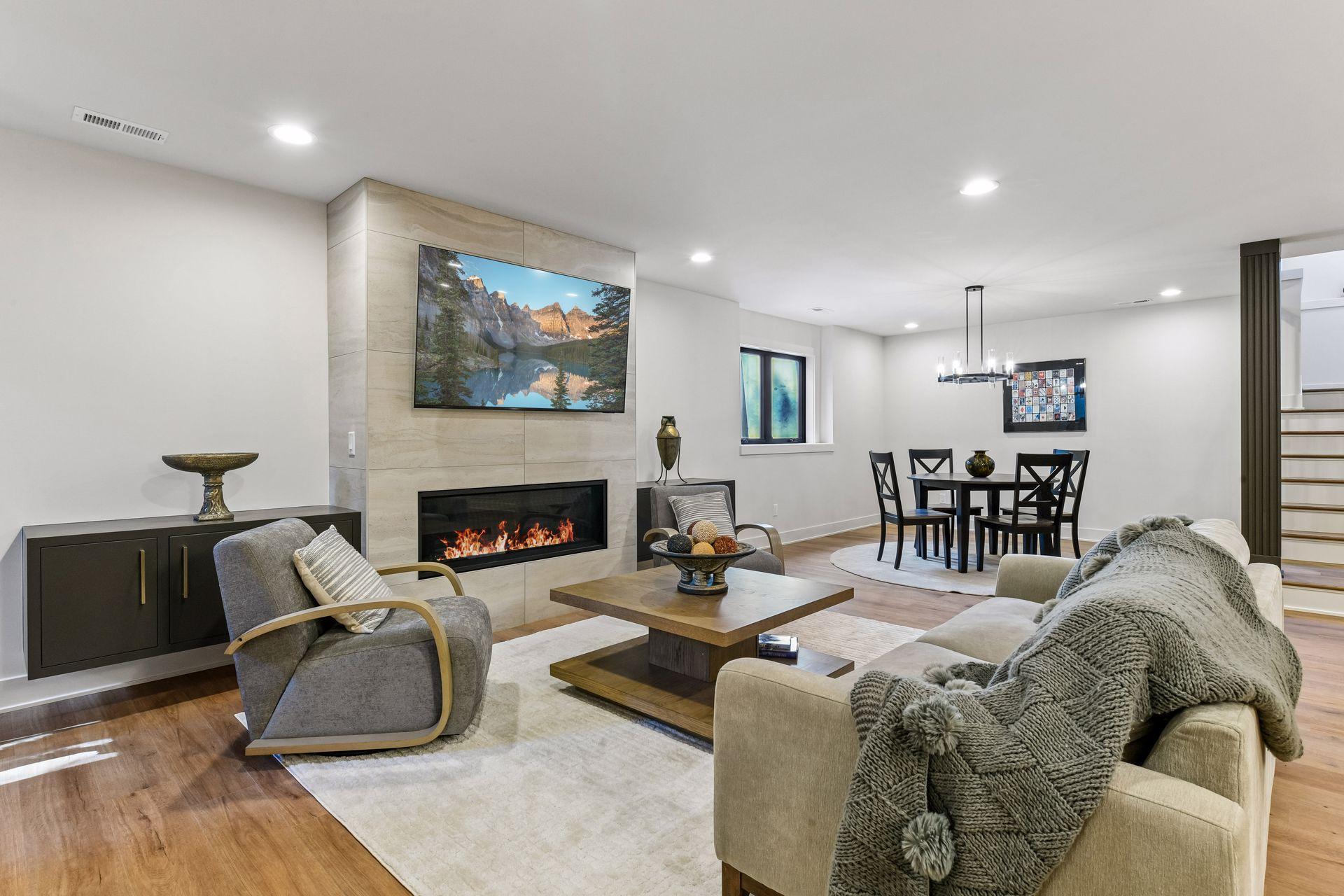 Lower level lounge area with linear fireplace and built-in TV.