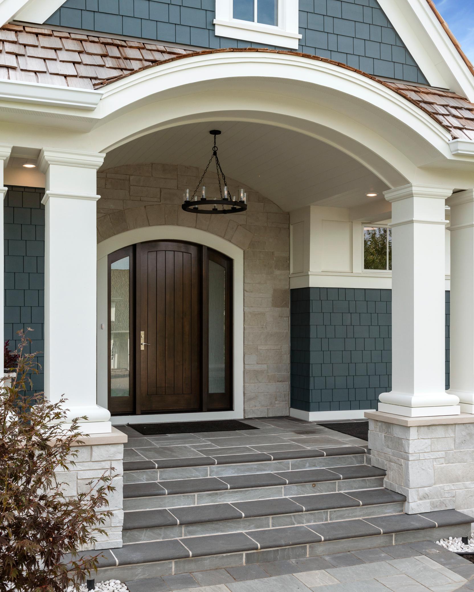 Stunning entryway to greet guests with solid stone steps and barrel vault porch