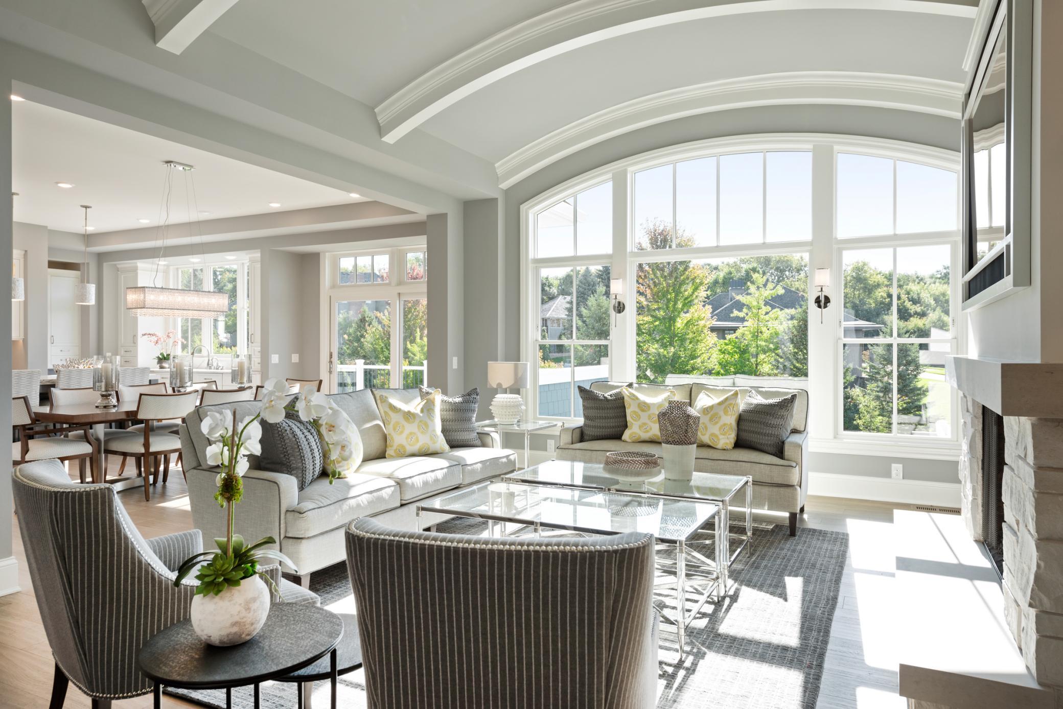 Step into the Great Room and cozy up by the stone fireplace framed by custom built-ins and a sleek media wall which is perfect for relaxing or entertaining