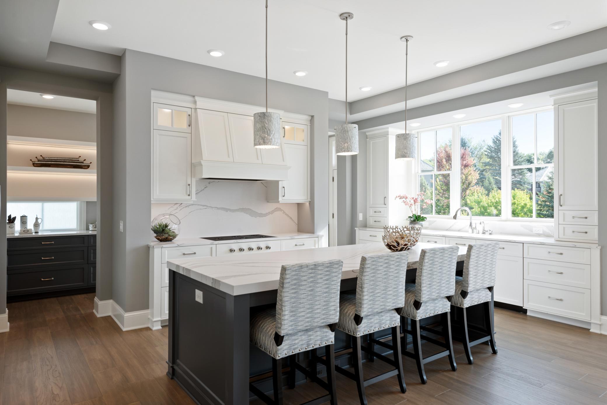 Kitchen features include Thermador cooktop and refrigerator, oversized kitchen island, and serene views