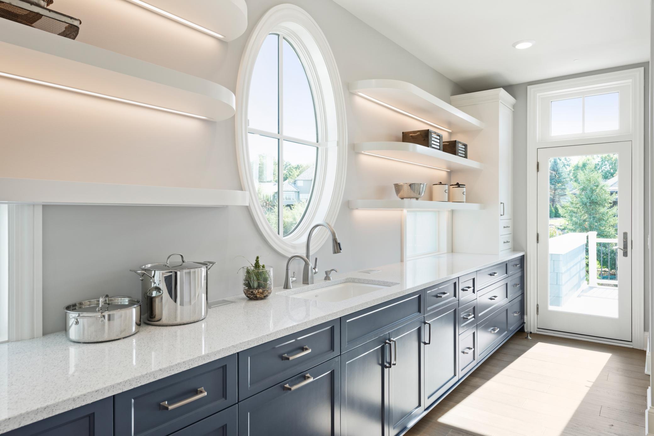 Walk-in pantry with additional sink, counter space, and shelving for storage/display