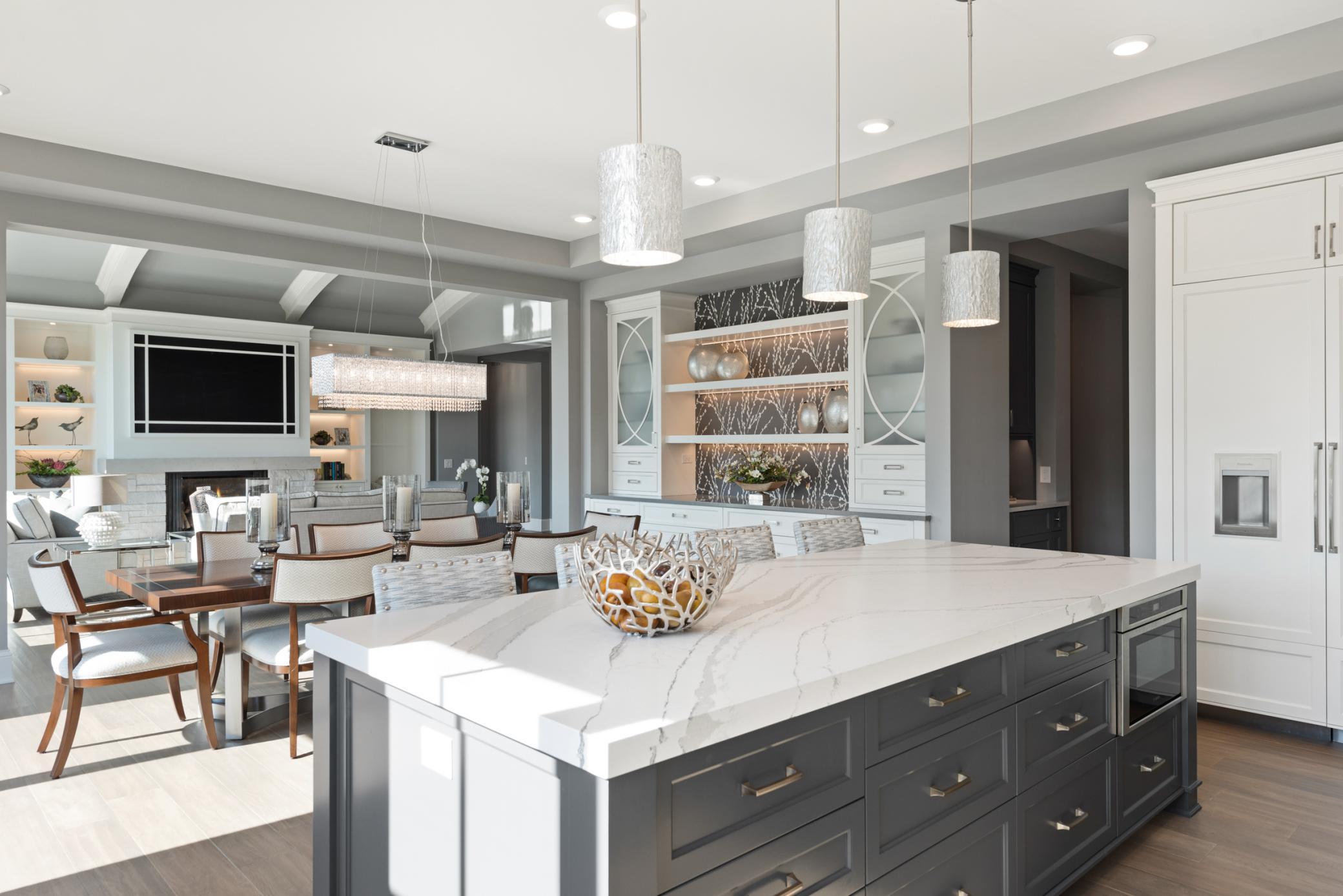 Designer lighting, kitchen island seating, and lots of room to entertain