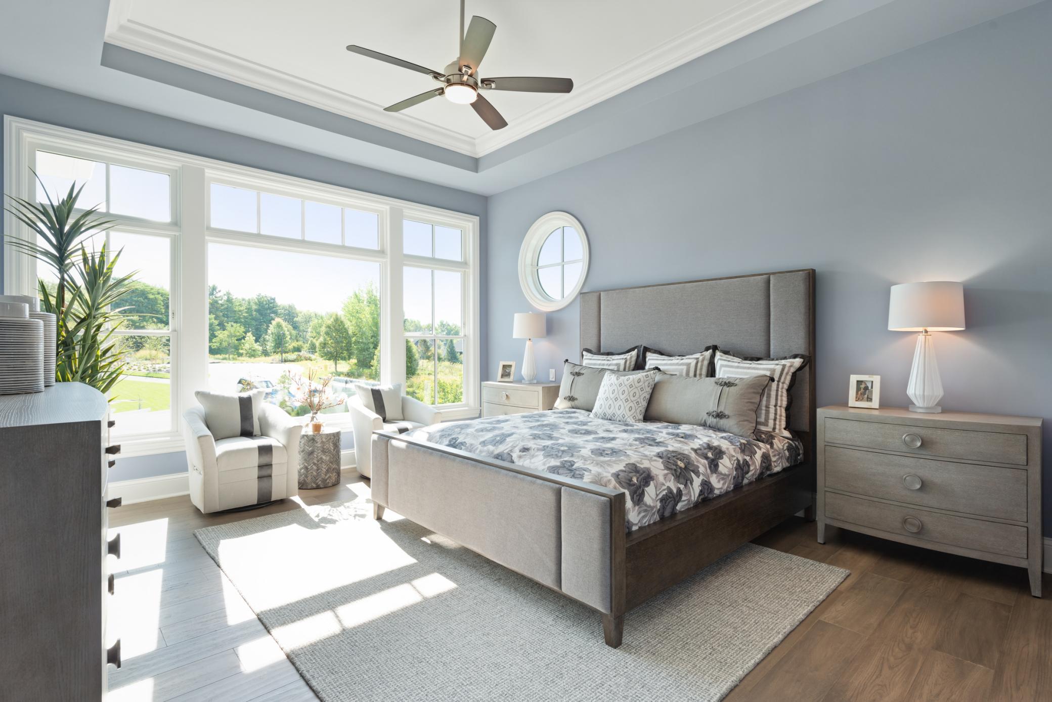 Step into the luxurious primary bedroom with stunning oversized windows and coffered ceilings.