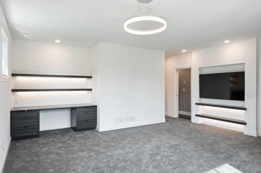 Second bedroom on the lower level with a desk, walk-in closet, and en-suite bathroom