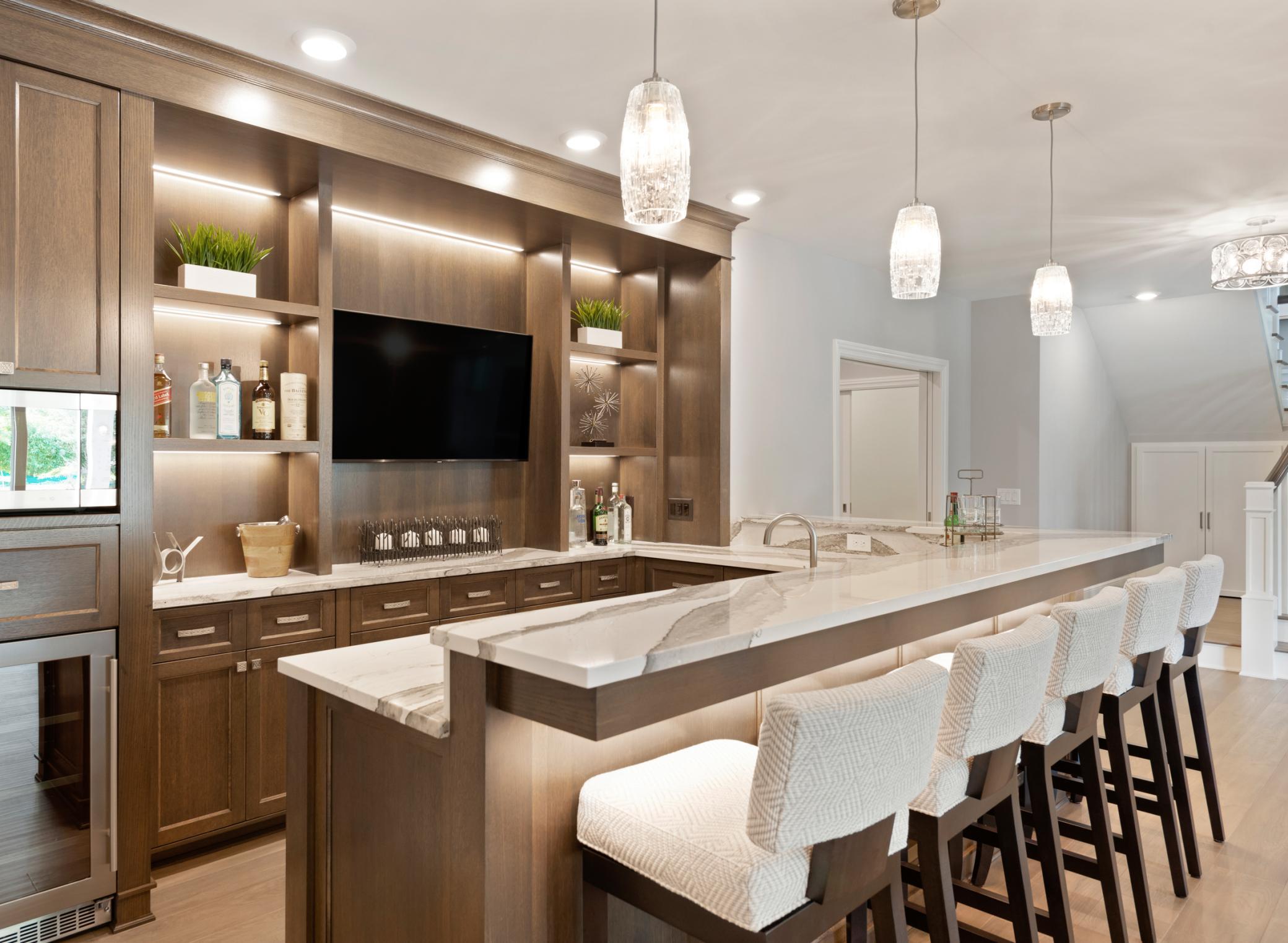 Lower level bar features a sink, dishwasher, and a beverage fridge
