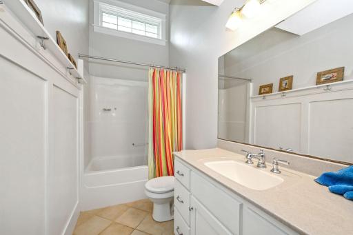Upper level full hall bath with vaulted ceiling and natural light