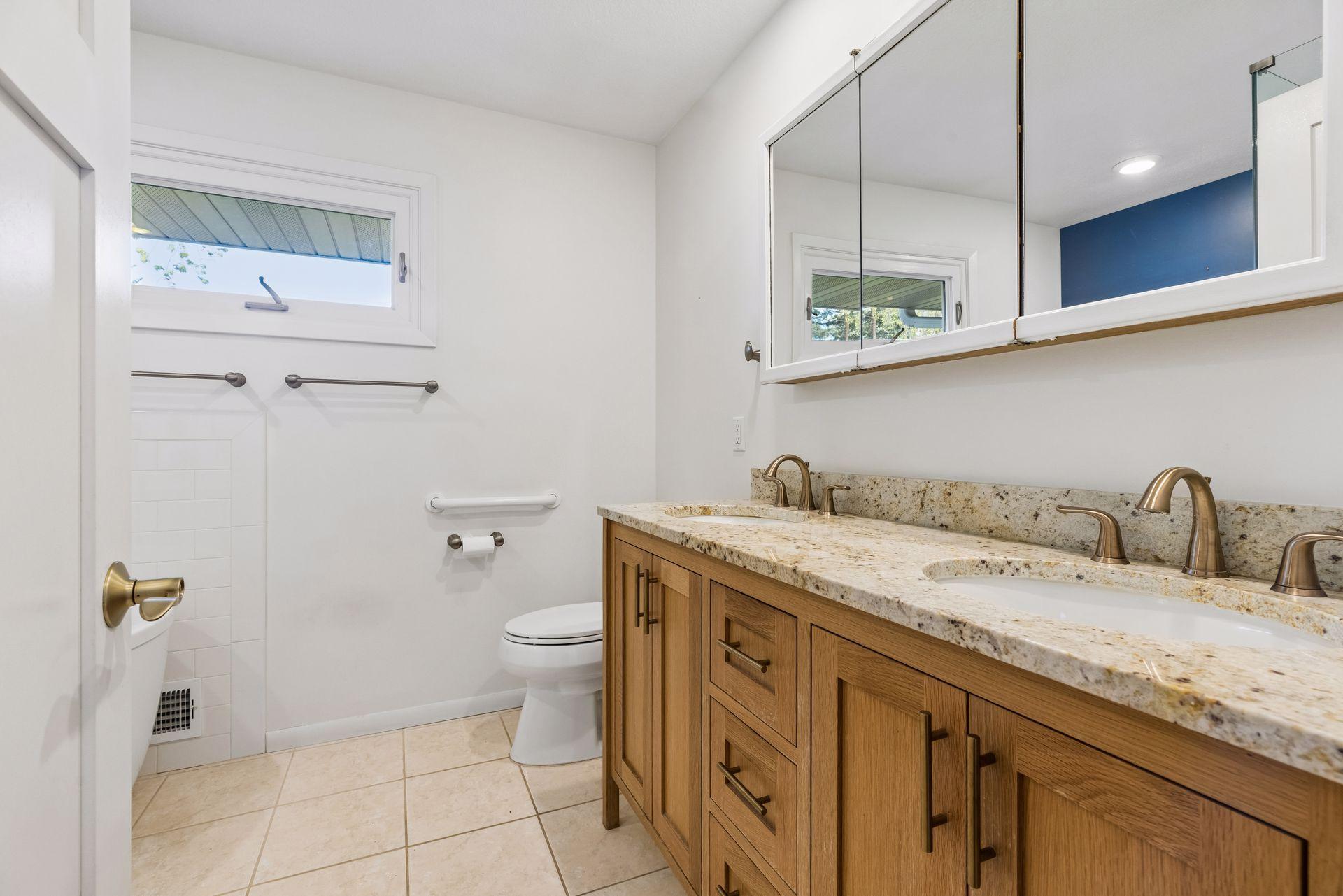 Here is the main floor full bathroom with dual sinks and lots of storage.