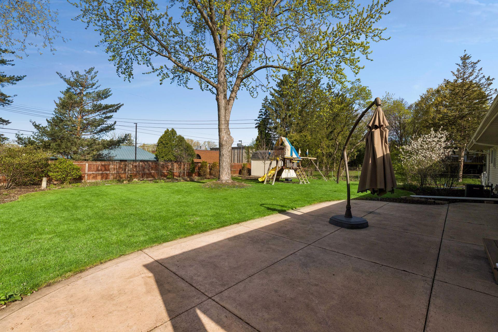 Off of the kitchen is a perfect patio space to enjoy the lush gardens and yard.
