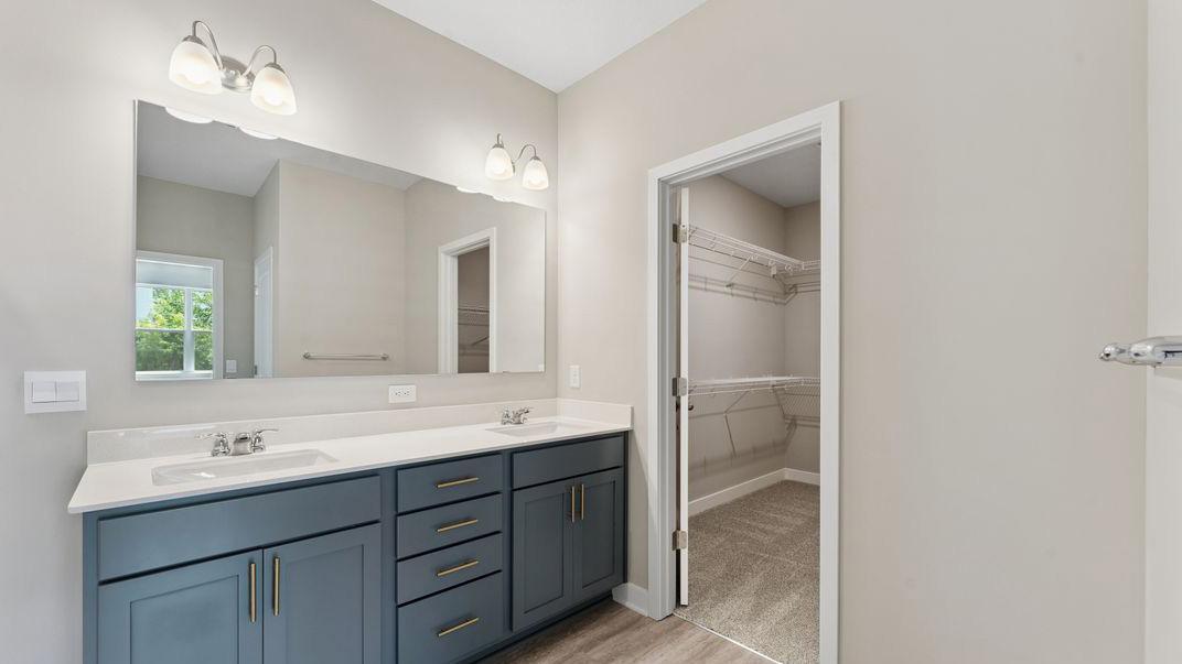 No need to share one sink when you get your own! Separate vanities to get ready in the morning or night. Spacious closet! Model photo. Options and colors will vary in our available inventory homes.
