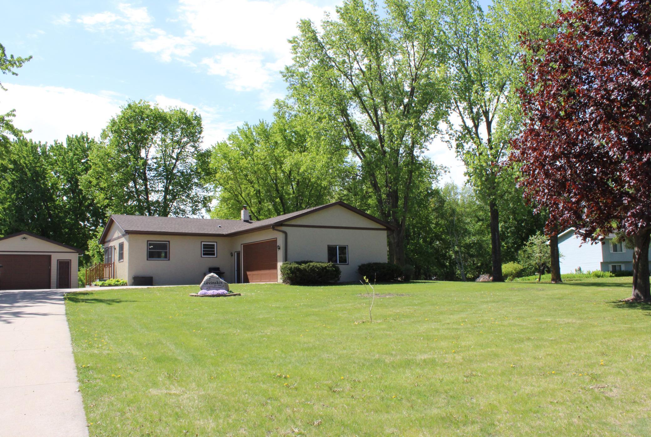 View of the home and detached garage from the road
