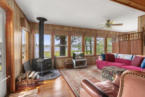 Living room is surrounded by large windows allowing natural light to flood the room.