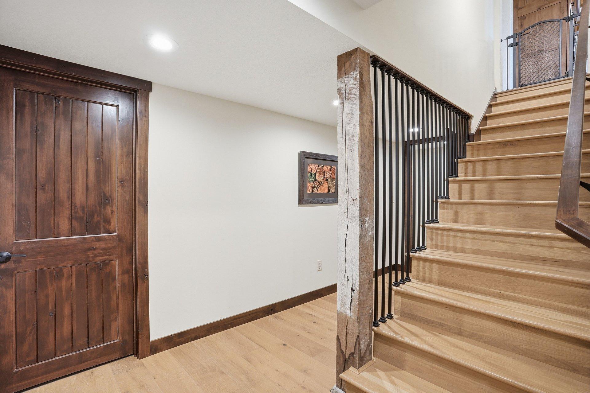stairs to lower level with original support beam