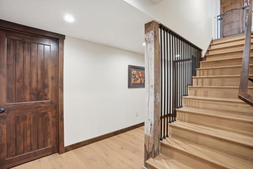 stairs to lower level with original support beam