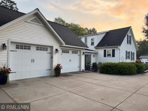 Home features large garage with lots of concrete driveway