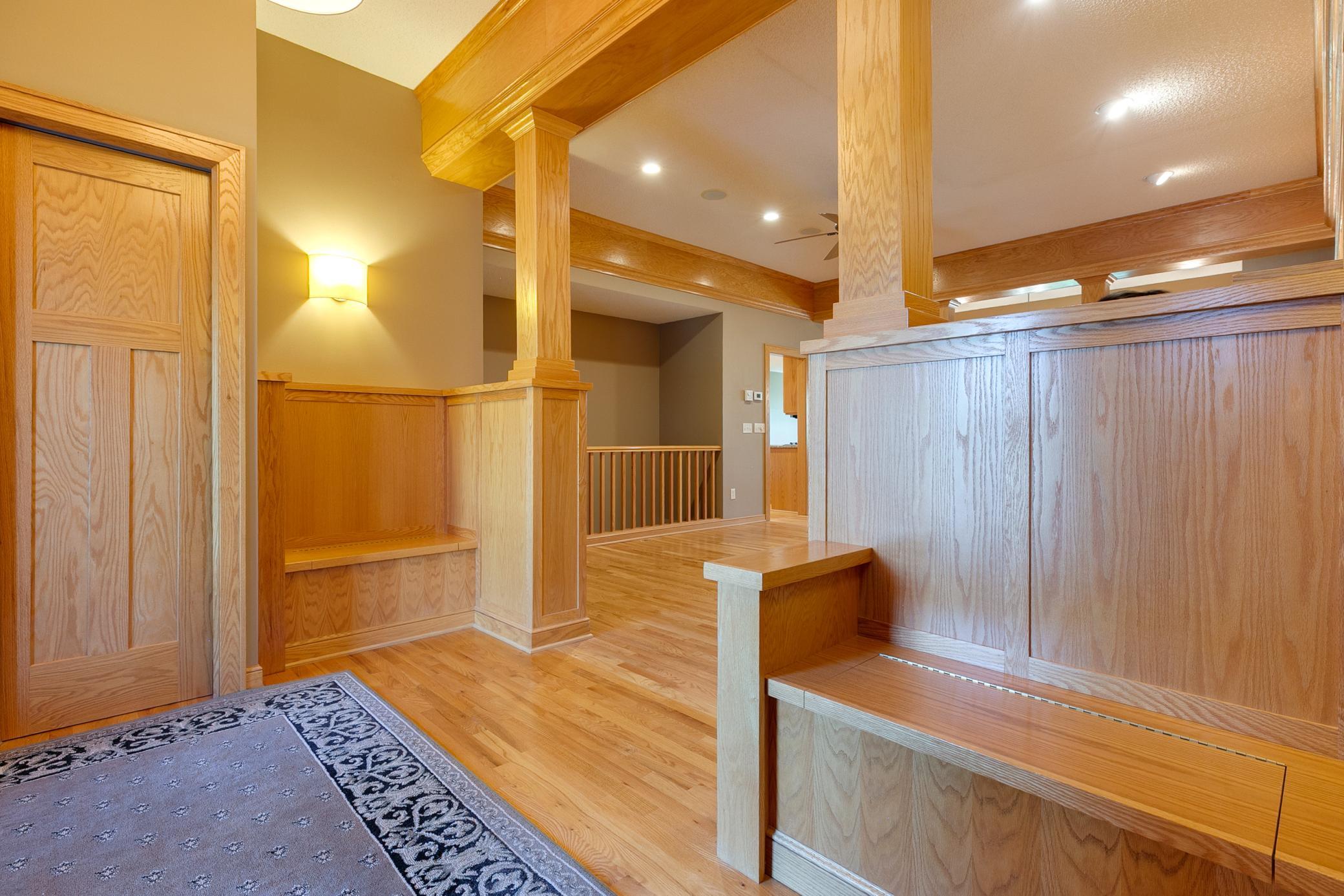 Welcoming foyer features two entry benches with built-in storage
