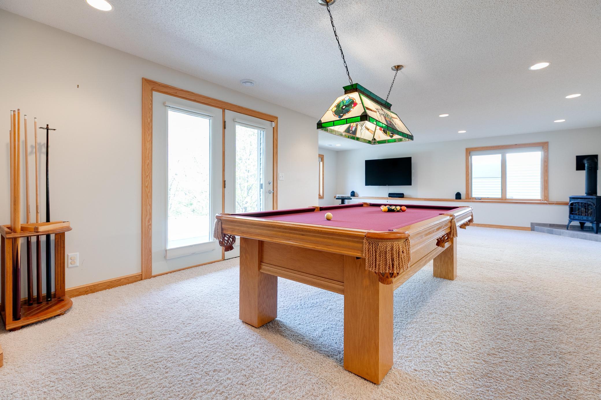 The walkout lower level has a spacious entertainment room - perfect for enjoying quality time with family and friends. The pool table and accessories will stay with the home.