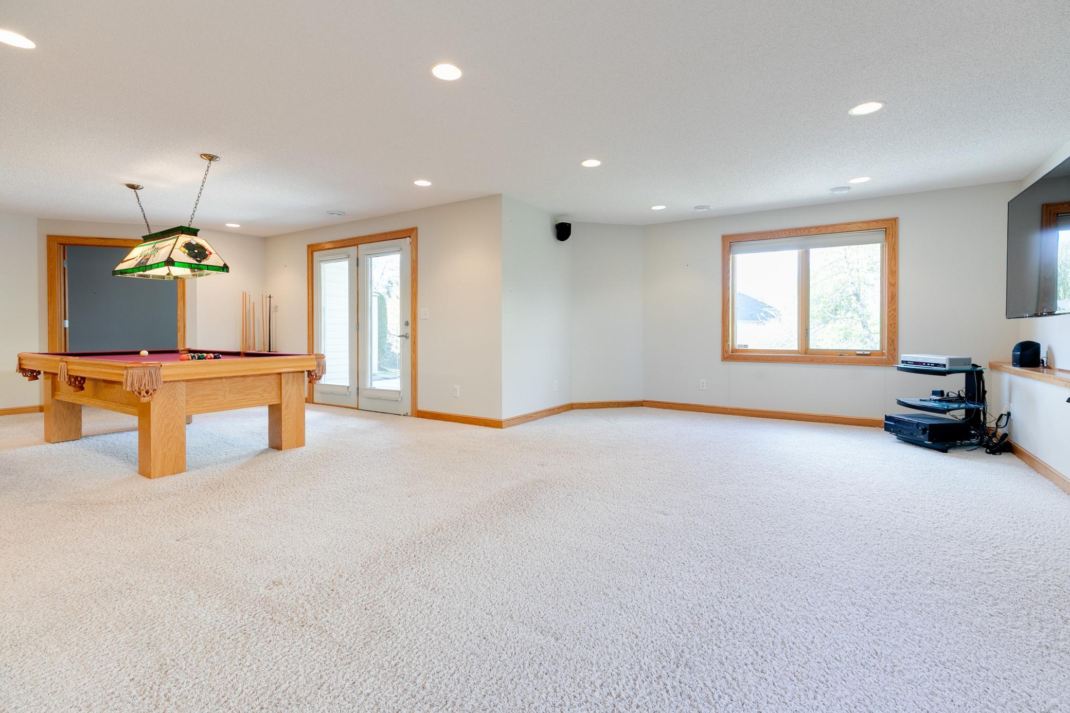 The lower level family room offers a spacious space for family gatherings or in-home movie nights.