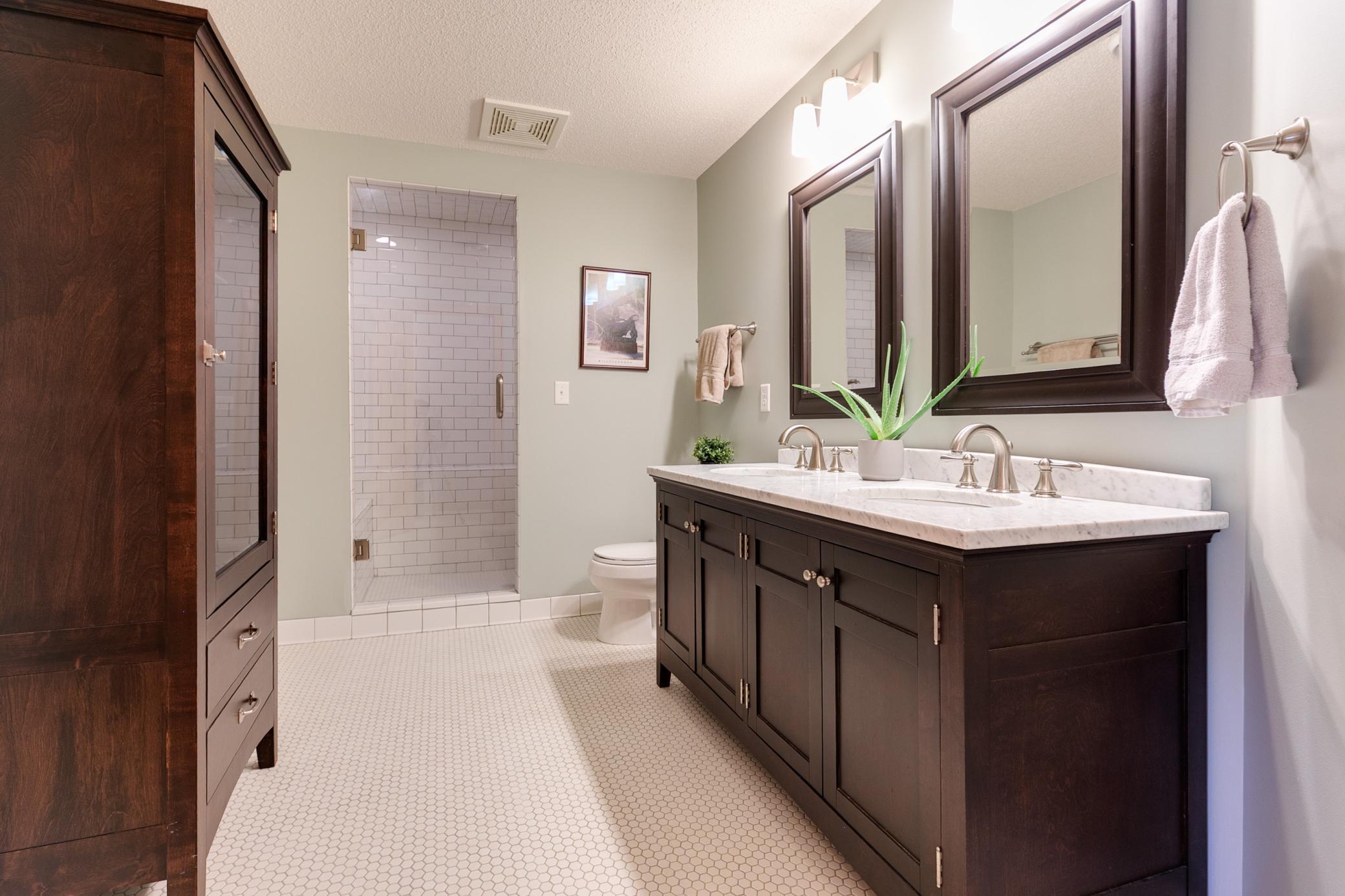 There is a steam shower on the lower level for added convenience. The freestanding linen closet will stay with the home.