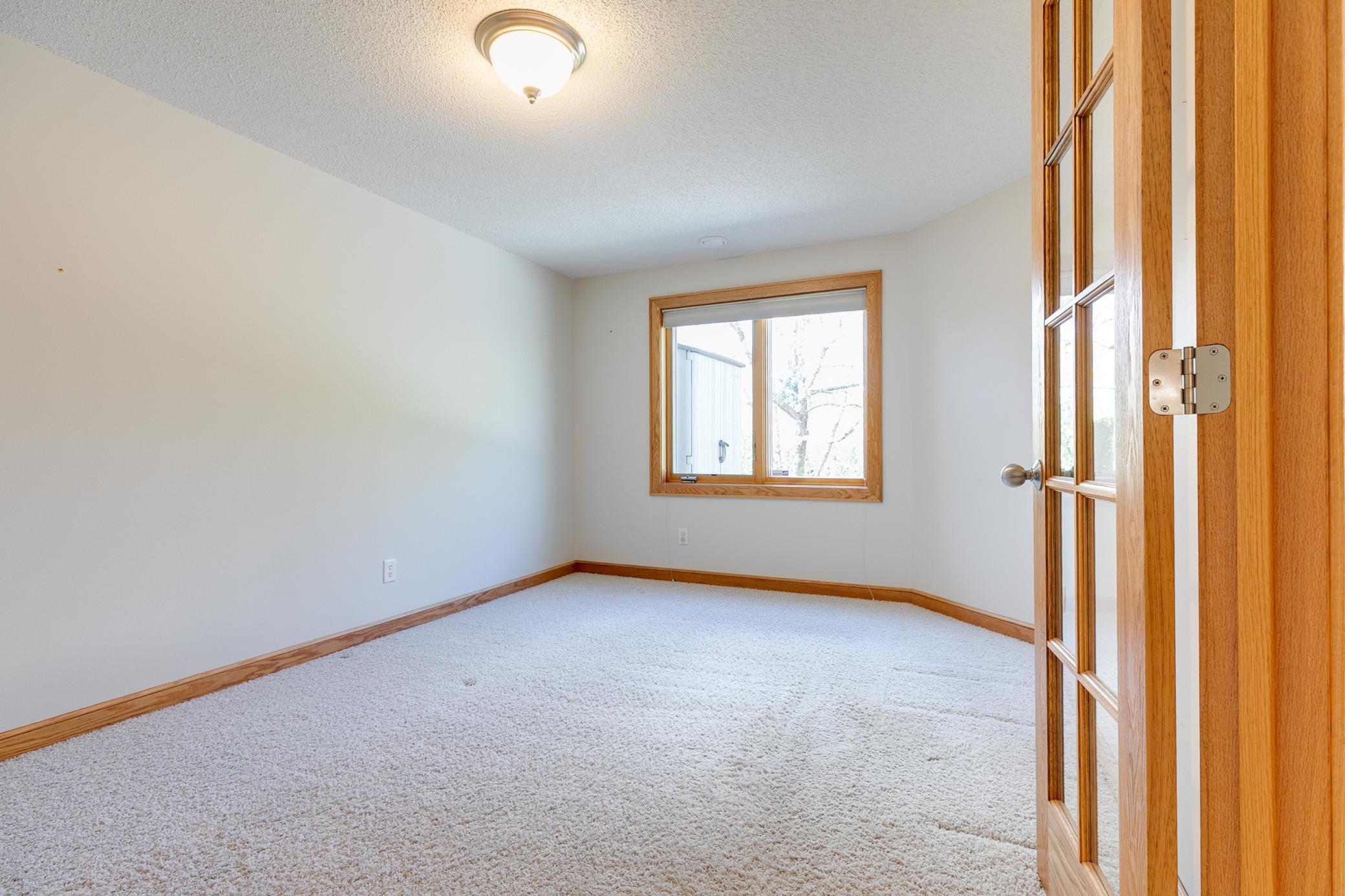 Lower level bedroom with french doors.