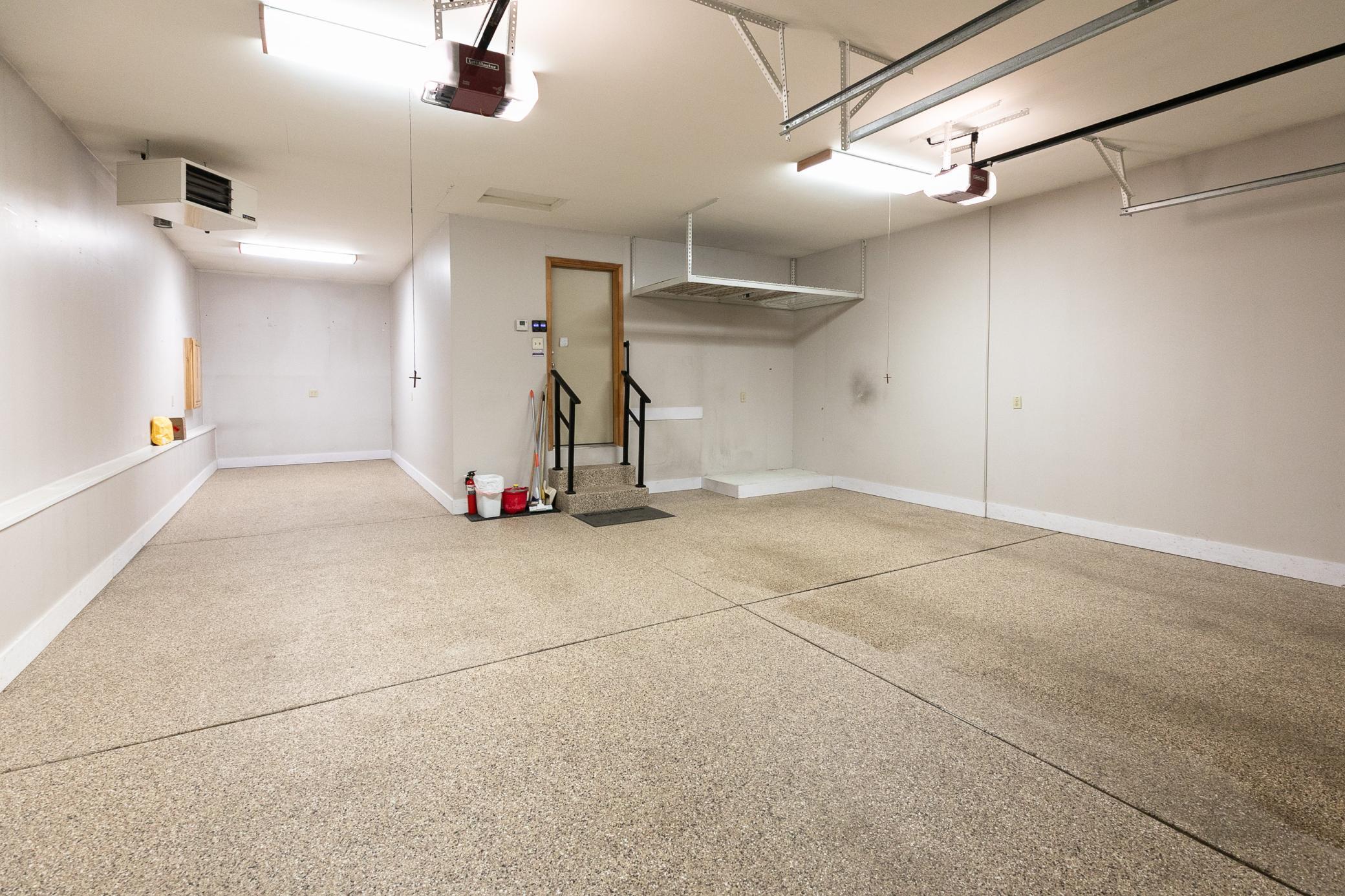 This heated and insulated 3 car garage features epoxy flooring, two garage door openers and an overhead storage area.
