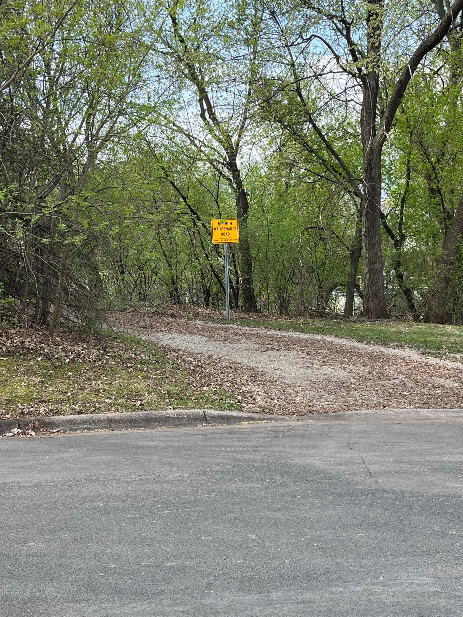 The lot is accessed by this private road. Only the adjacent property facing the street uses it to get to their driveway. There is an easement allowing ingress and egress.