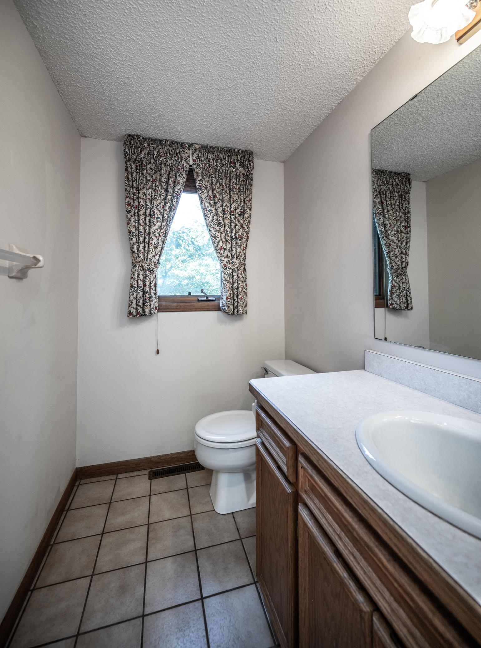 Half bath on the main level has ceramic tile flooring