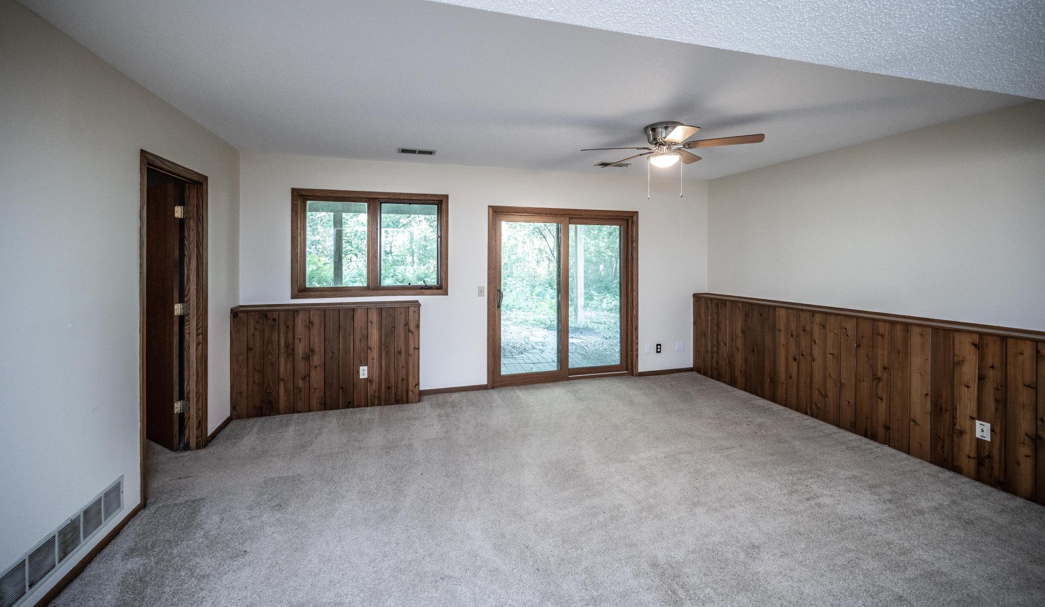 Another view of the lower level family room with a sliding glass door leading to the back yard