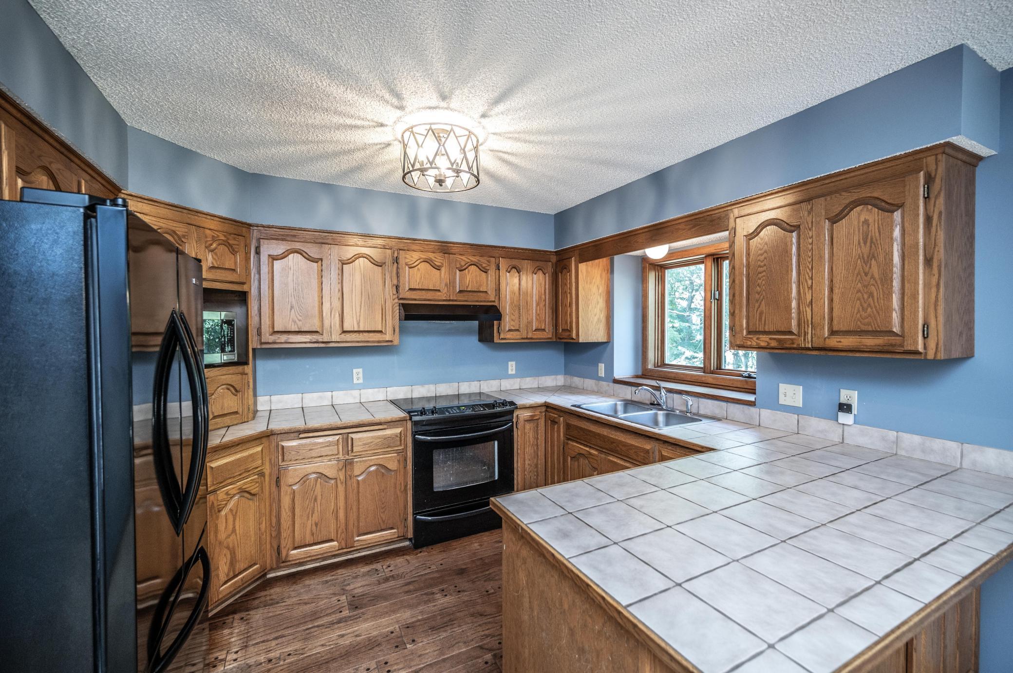 Spacious kitchen features ample counter space, a kitchen window and opens to the informal dining area