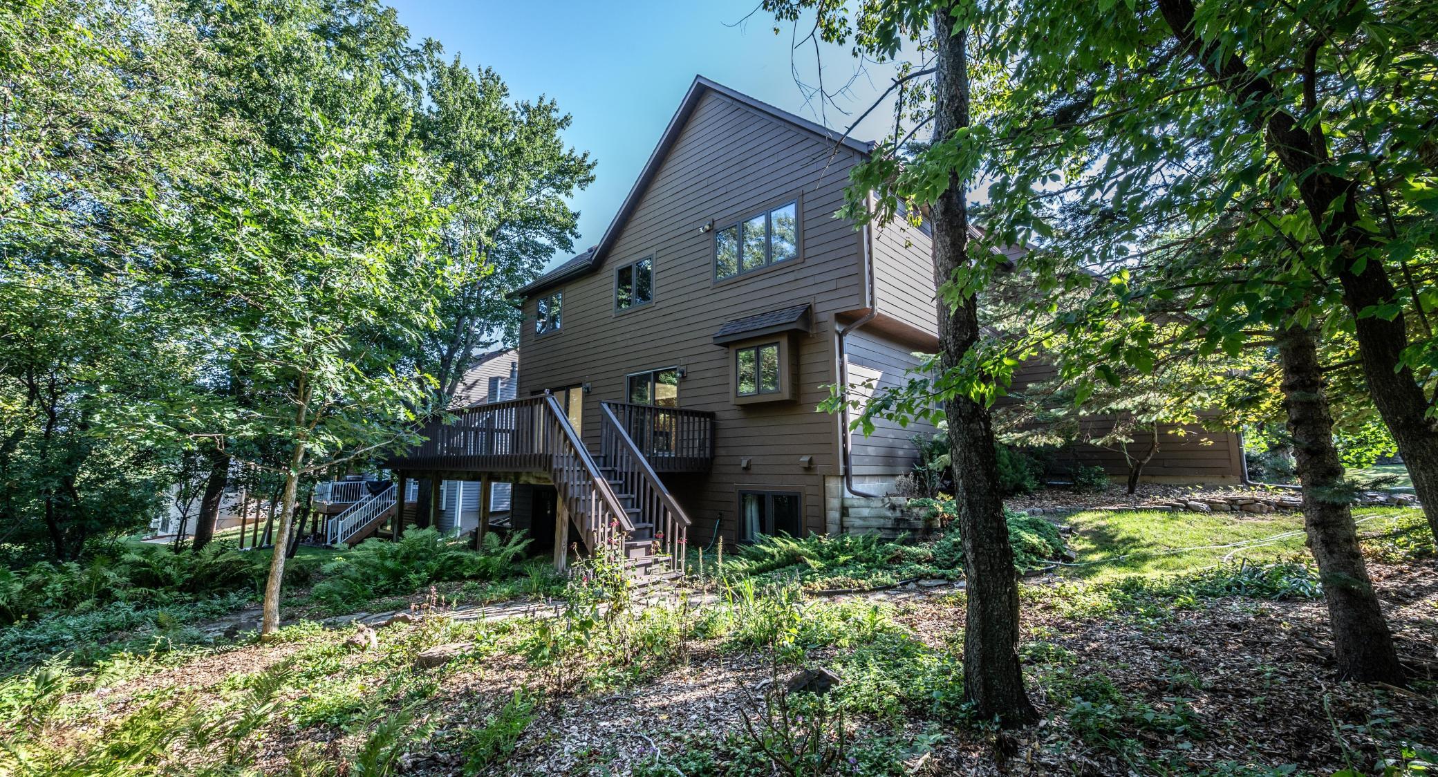 Backyard has been left natural with perennials , walking paths and lots of trees. Lot is nearly 1/2 acre.
