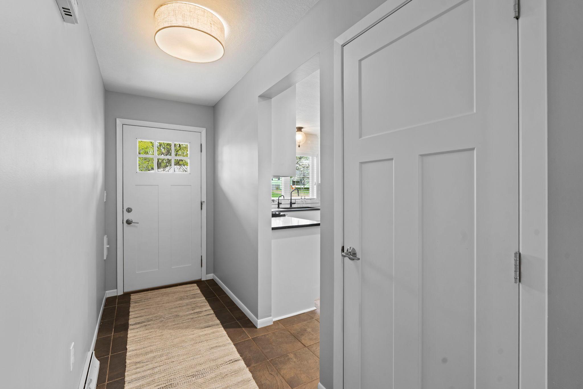 Ceramic tiled foyer, gorgeous white woodwork and Craftsmans style, white doors throughout.