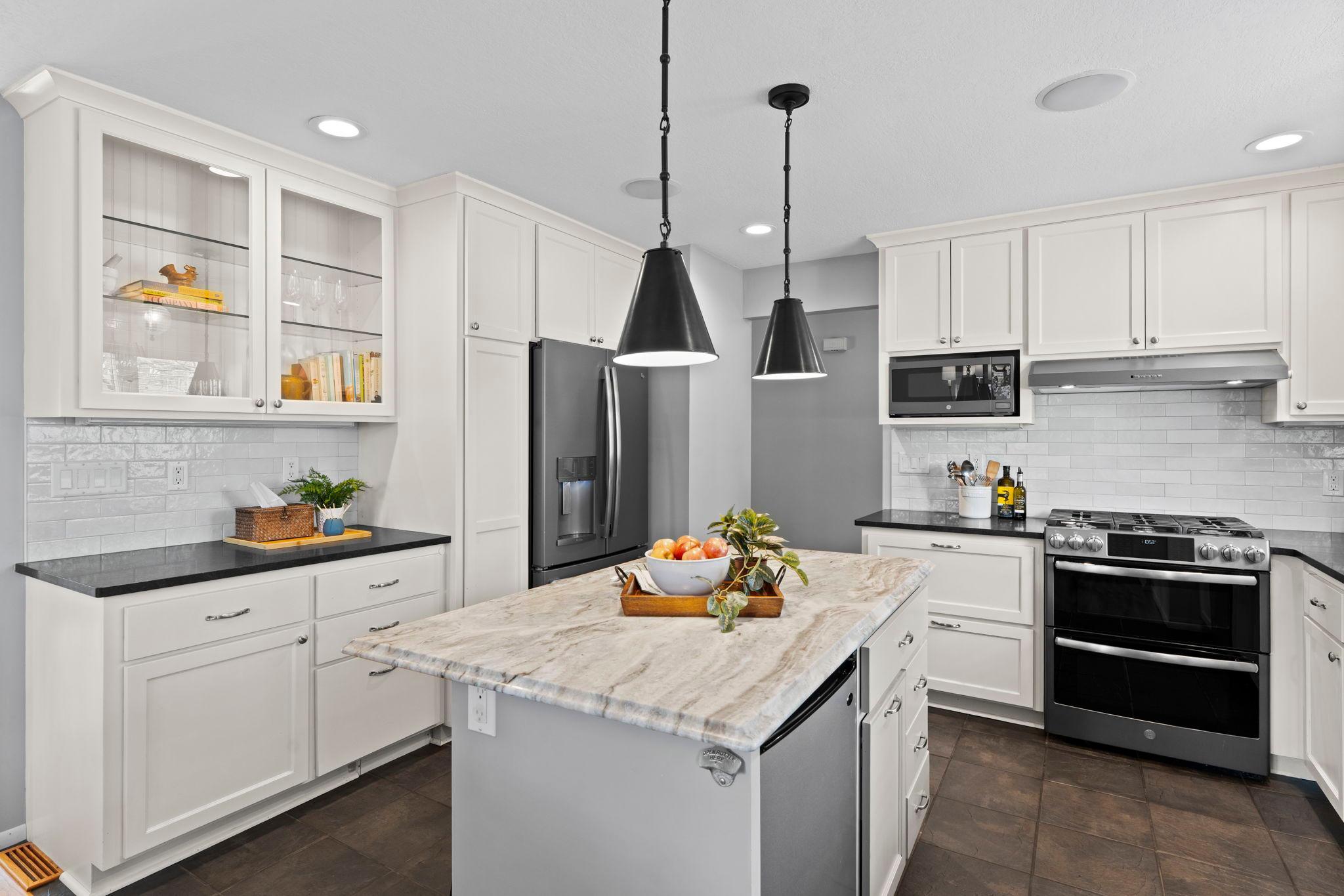 Abundance of kitchen cabinetry, drawers, beverage fridge is an awesome addition to this kitchen.