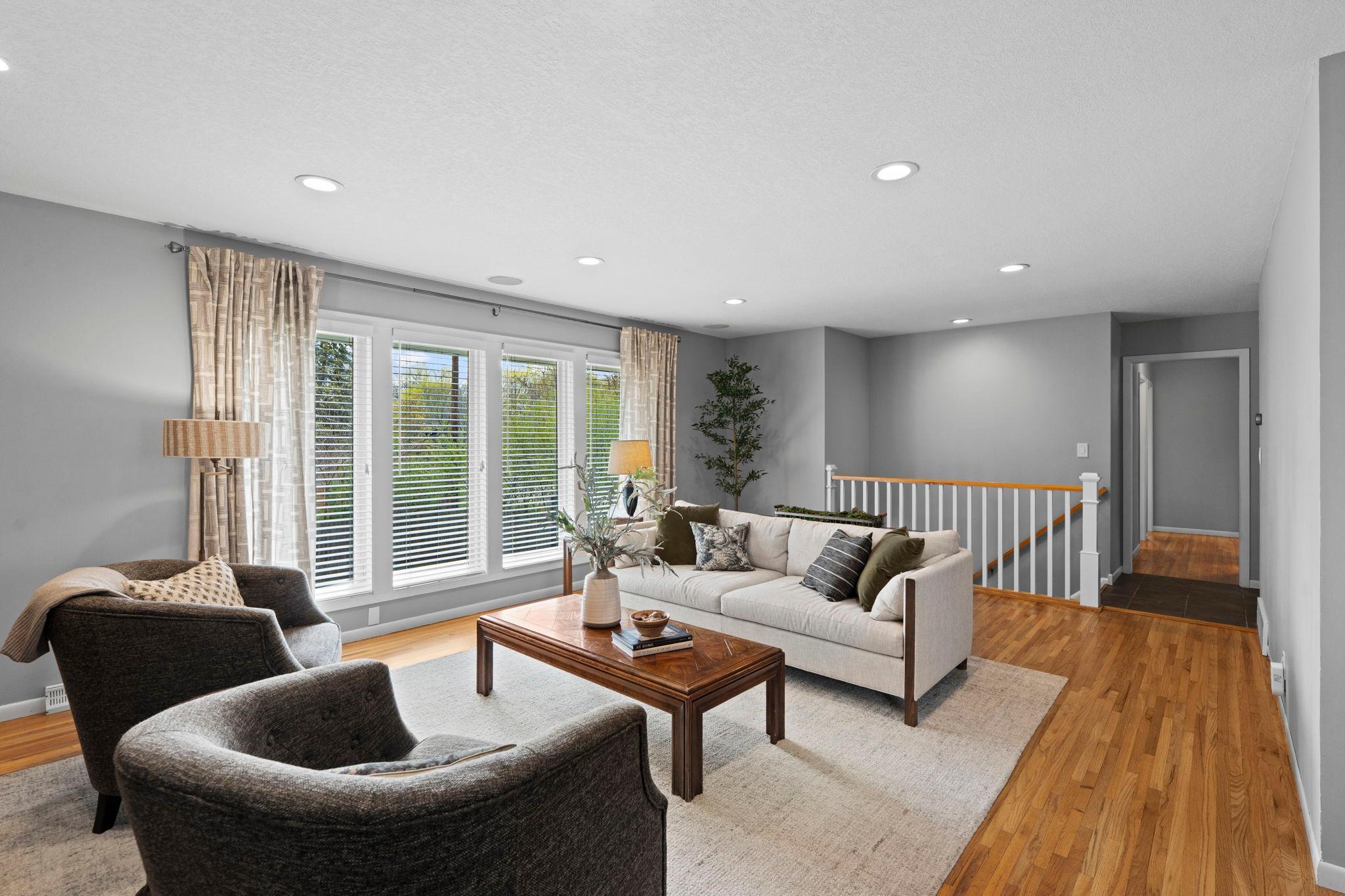 Gorgeous, refinished hardwood floors span the main level dining, living, and all three main level bedrooms.