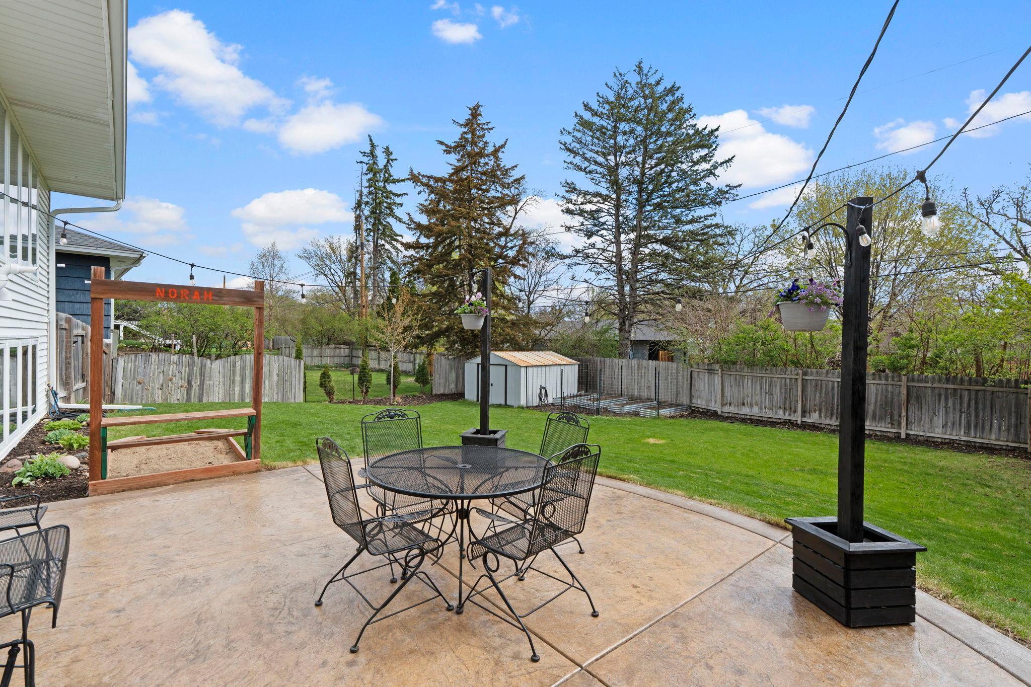 Stampe concrete patio overlooks private backyard.