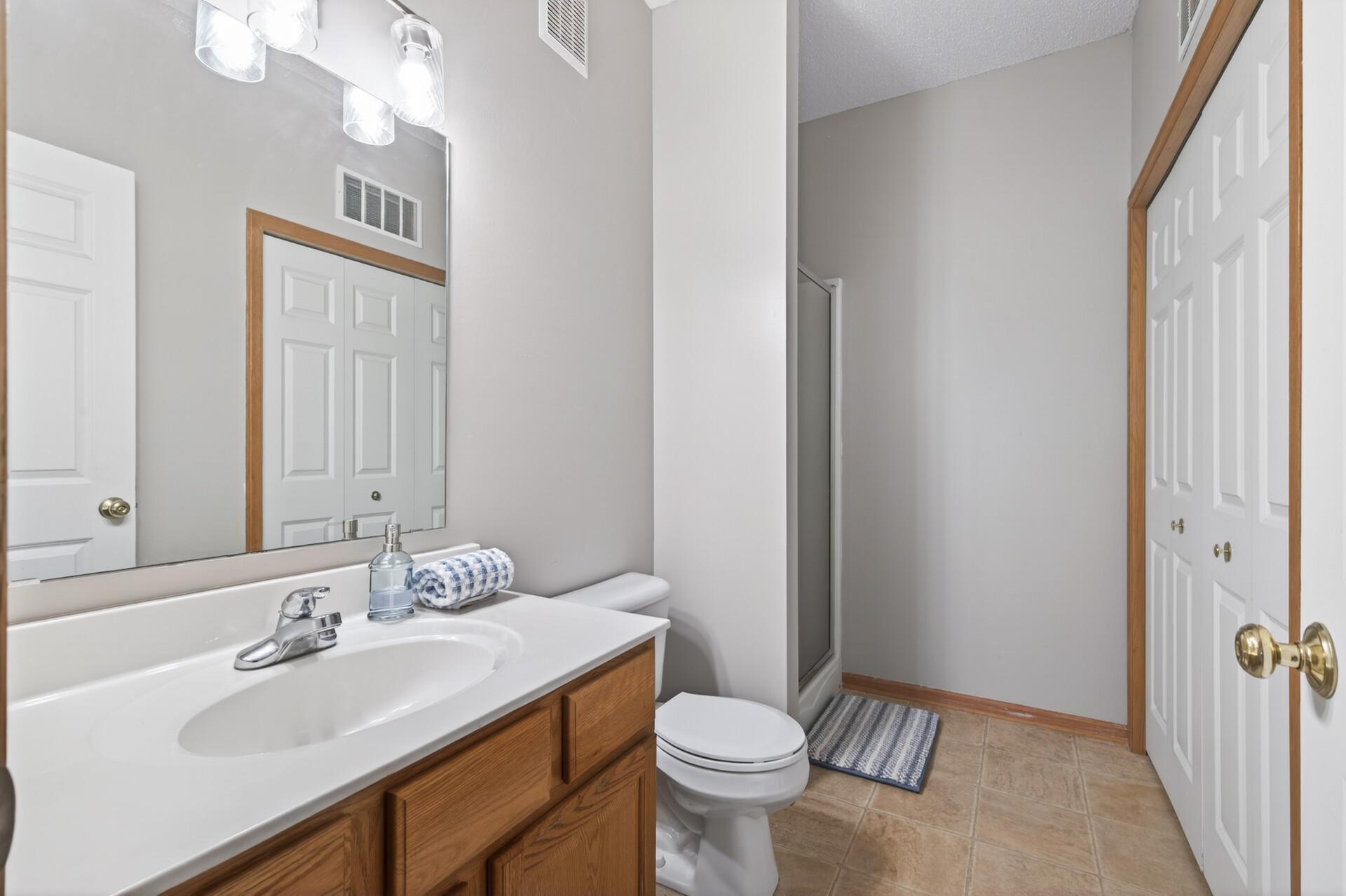 The main level 3/4 bath contains the laundry closet.