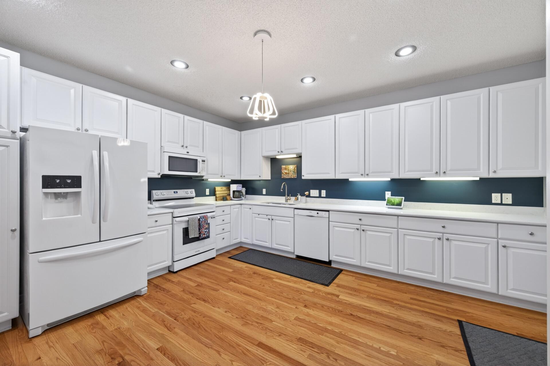 New quartz countertops in the kitchen and freshly re-finished hardwood floors.