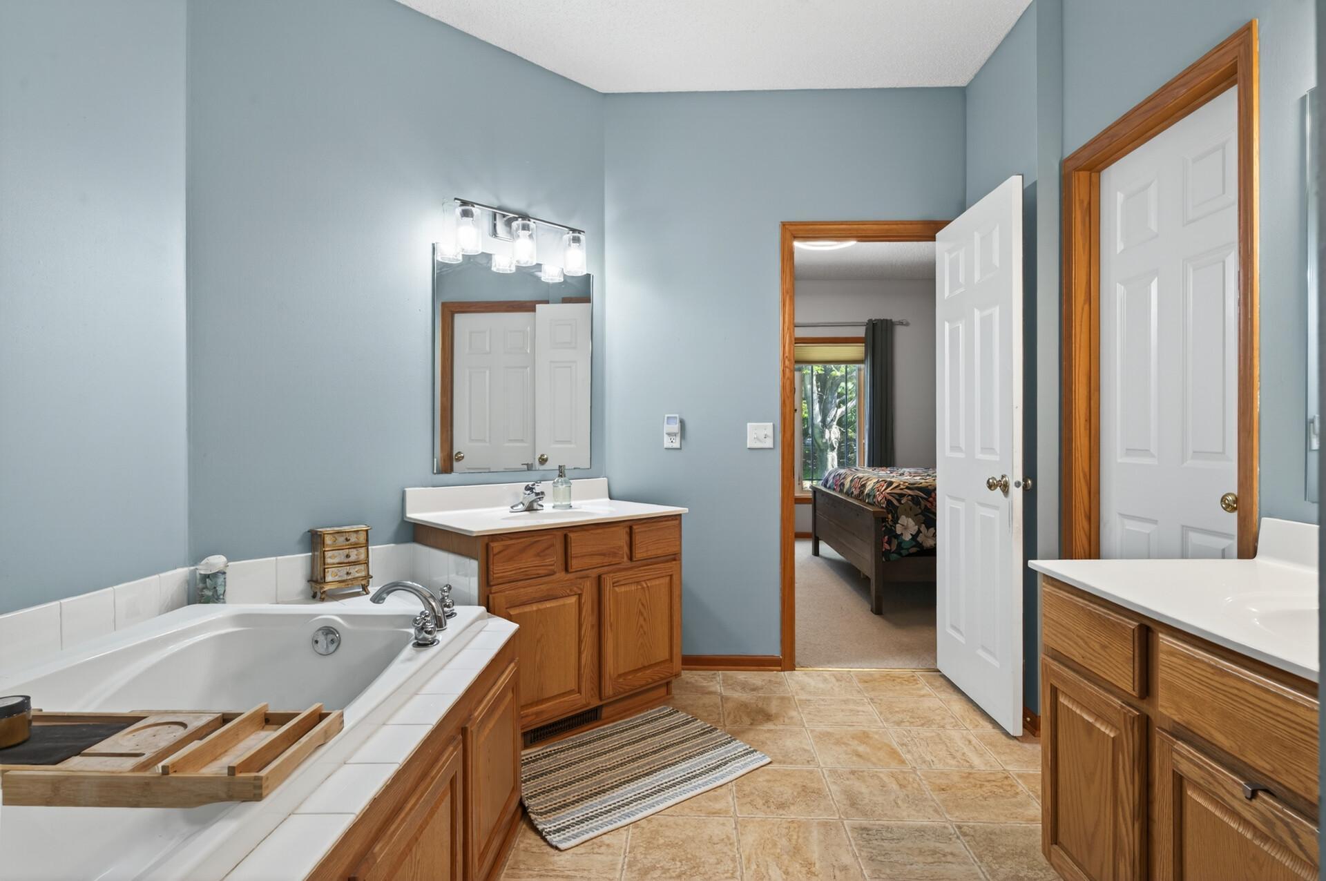 Private primary suite with separate tub, shower, and walk in closet.