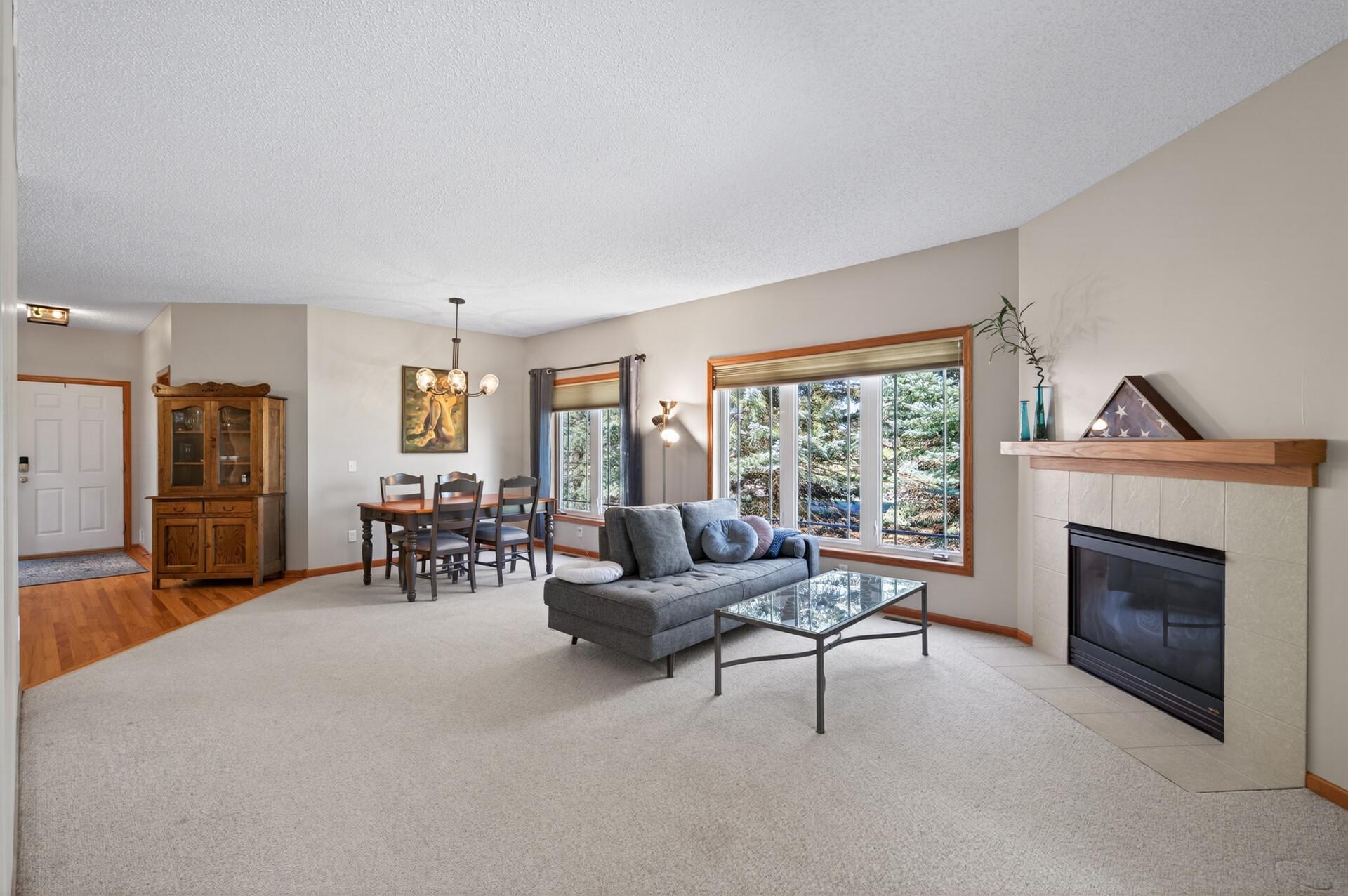 Cozy gas fireplace and oversized sunny windows.
