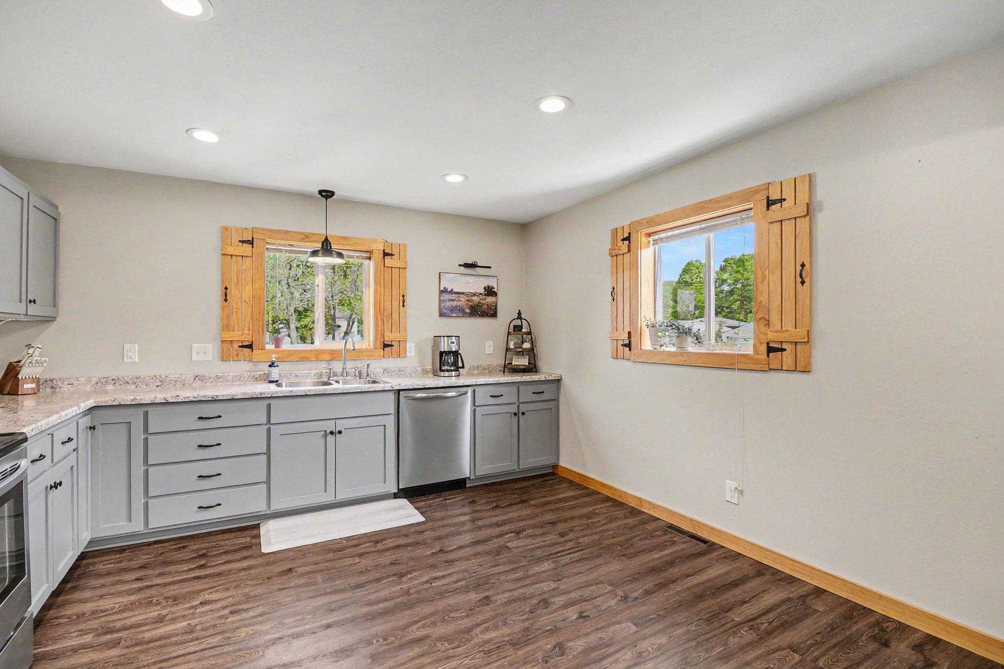 Open kitchen layout with large pantry, ample cabinet storage, and modern fixtures — Tri City United SD