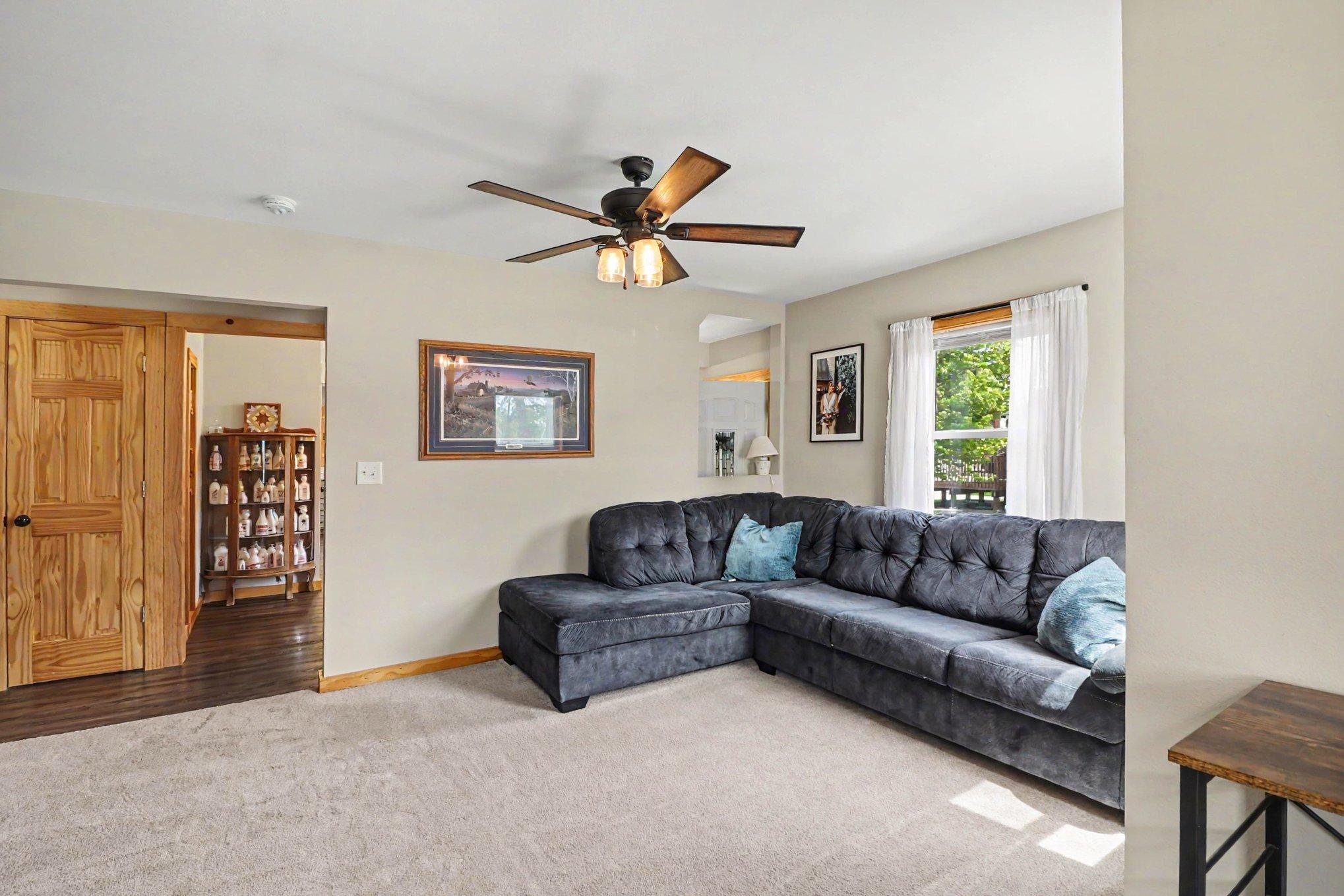 Second angle of main floor living area showing 6-panel solid doors and open flow toward kitchen
