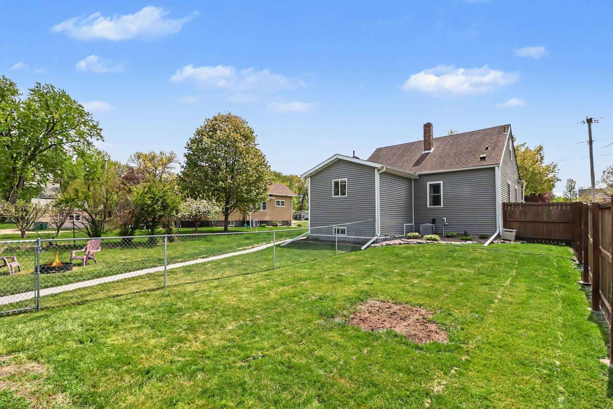 Partially fenced yard at 305 Oak Ave SE — room to play, garden, or expand the fenced area
