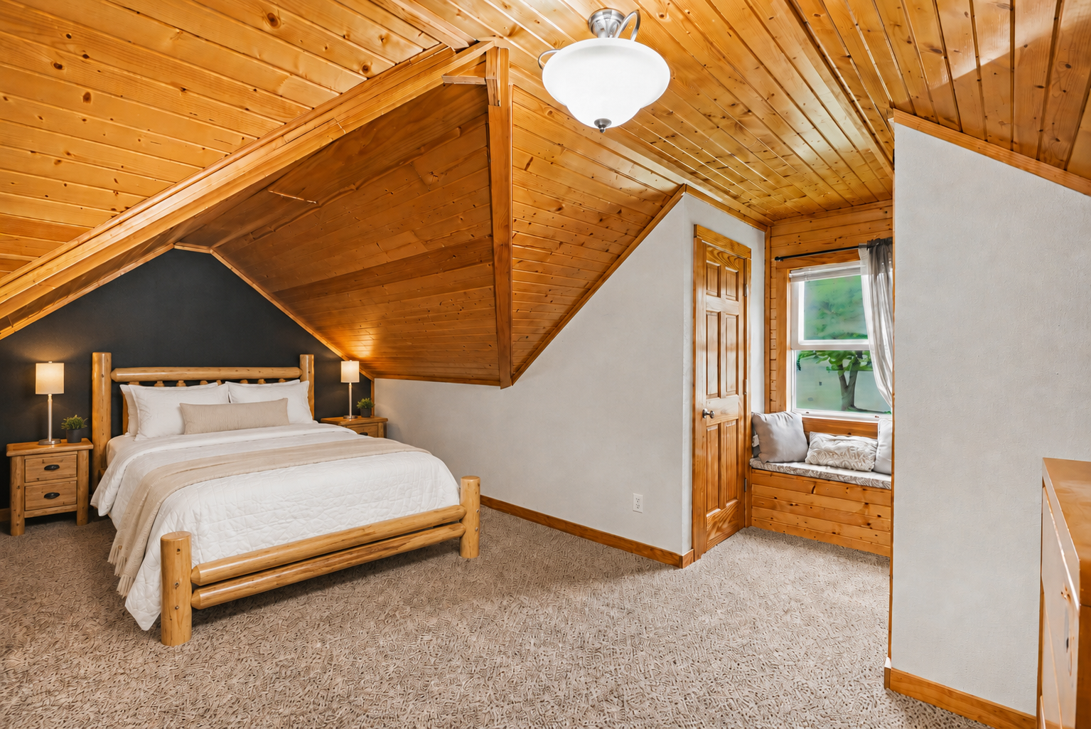 Upper level primary suite with tongue-and-groove pine ceiling, window bench seat, and three closets
