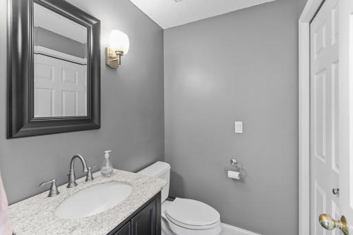 The main floor half bath with granite vanity top.
