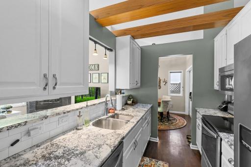 The kitchen has plenty of countertop space and is open to both the dining and living rooms.