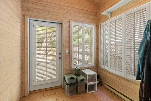 Cute and cozy 4-season porch with wood shutters.