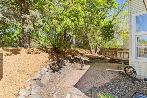 The backyard requires very little maintenance, with a brick patio and deck.